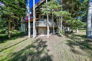 Exterior space with a deck, a patio area, and a yard