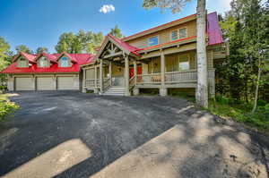 View of front facade with a porch and a garage