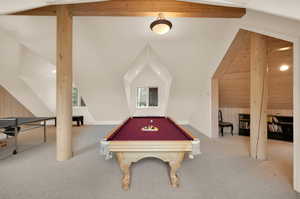 Rec room featuring carpet flooring, lofted ceiling with beams, wooden walls, and billiards