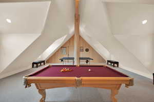 Game room with billiards, wood walls, lofted ceiling, and carpet