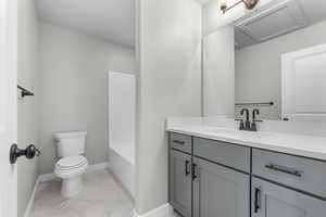 Full bathroom with shower / washtub combination, vanity, tile patterned floors, and toilet