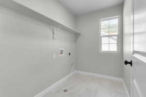 Laundry room with light tile patterned flooring, hookup for a washing machine, and electric dryer hookup