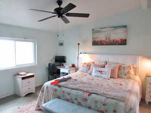 Bedroom with hardwood / wood-style flooring and ceiling fan