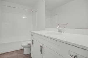 Bathroom with vanity, toilet, and tile floors