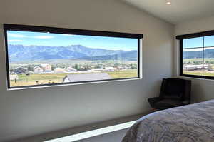 Carpeted bedroom with a mountain view