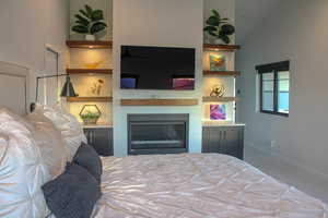 Bedroom featuring high vaulted ceiling and carpet flooring