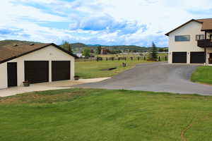 View of yard with a garage and a mountain view