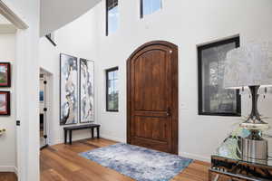 Entrance foyer featuring wood-type flooring and a high ceiling