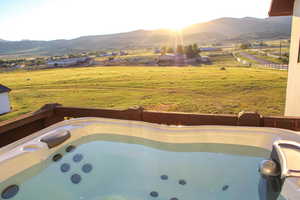 Exterior space with a mountain view and a hot tub