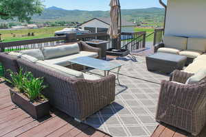 Wooden terrace featuring outdoor lounge area and a mountain view