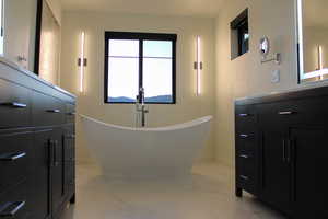 Bathroom featuring tile floors and a tub