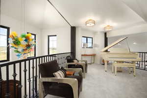 Living area featuring a wealth of natural light and carpet flooring