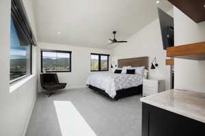 Bedroom with vaulted ceiling and light colored carpet