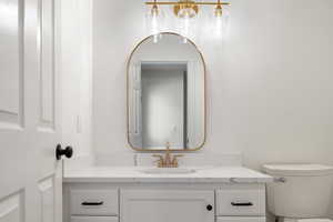 Powder room near garage entrance and hot tub entrance