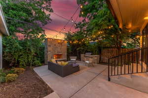 Cozy backyard with fireplace and grill