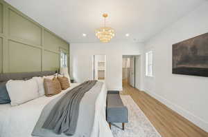 Primary bedroom with accent wall and access to the backyard patio and fireplace