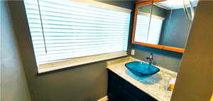 Bathroom with vanity with extensive cabinet space