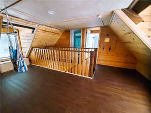 Additional living space with vaulted ceiling and hardwood / wood-style floors