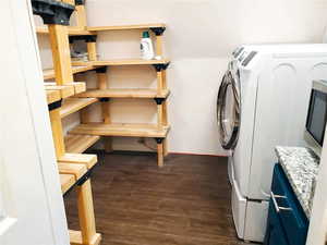 Laundry area featuring independent washer and dryer and dark wood-type flooring