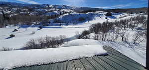 Snowy aerial view featuring a mountain view