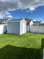 View of yard with a storage unit