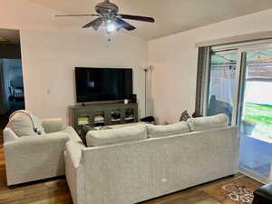 Living room with wood-type flooring and ceiling fan