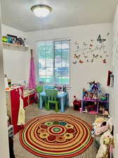 Game room with carpet flooring and a textured ceiling