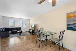 Dining area featuring wood-type flooring and ceiling fan