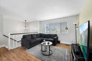 Living room featuring an inviting chandelier and hardwood / wood-style floors