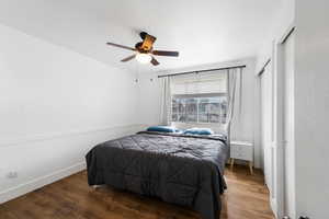 Bedroom featuring wood-type flooring and ceiling fan