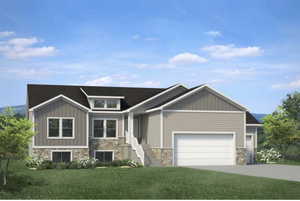 View of front of home with a garage and a front lawn