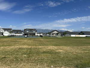 View of yard featuring a gazebo, a mountain view, and tennis court