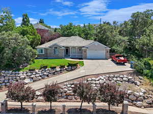 Ranch-style home with a front lawn and a garage