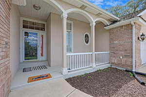 Doorway to property with a garage