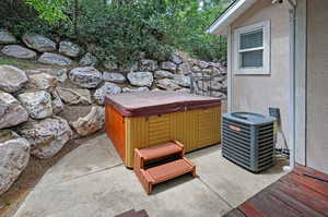 View of patio / terrace featuring a hot tub and central air condition unit