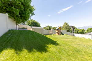 View of yard with a playground and a mountain view