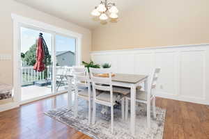 Dining room featuring plenty of natural light, an inviting chandelier, and hardwood / wood-style floors