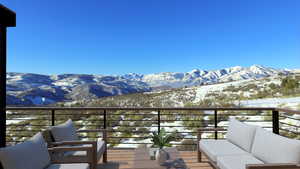 Snow covered back of property featuring a mountain view