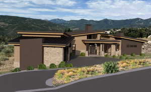 View of front of property with a mountain view and a garage