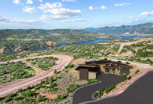 Birds eye view of property with a water and mountain view