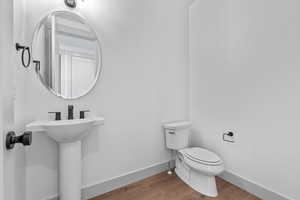 Bathroom with toilet and wood-type flooring