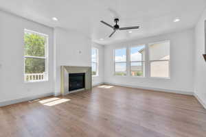 Unfurnished living room with light hardwood / wood-style flooring and ceiling fan