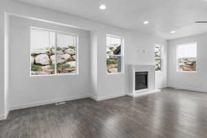 Unfurnished living room featuring dark hardwood / wood-style floors