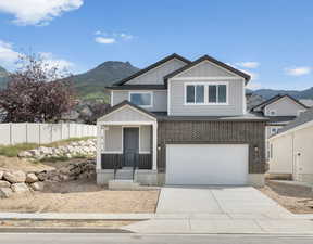 View of front facade with a garage and a mountain view