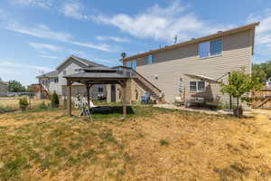 Rear view of property with a patio, a yard, and a gazebo