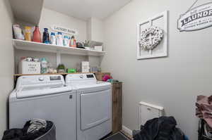 Laundry room with washer and clothes dryer