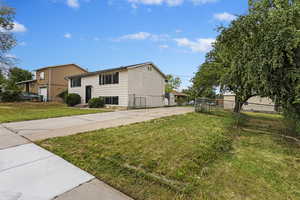 View of side of home with a lawn