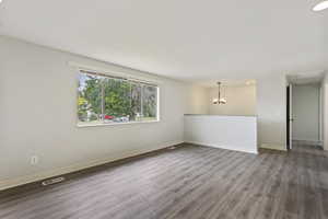 Interior space featuring a notable chandelier and wood-type flooring