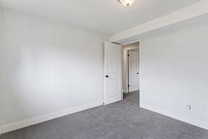 Unfurnished room with dark carpet