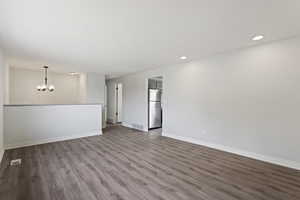 Interior space with wood-type flooring and an inviting chandelier